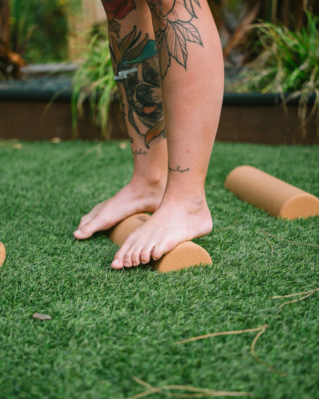 Bare feet standing on The Nude Foot cork foam rollers for post-WOD foot recovery, balance and mobility