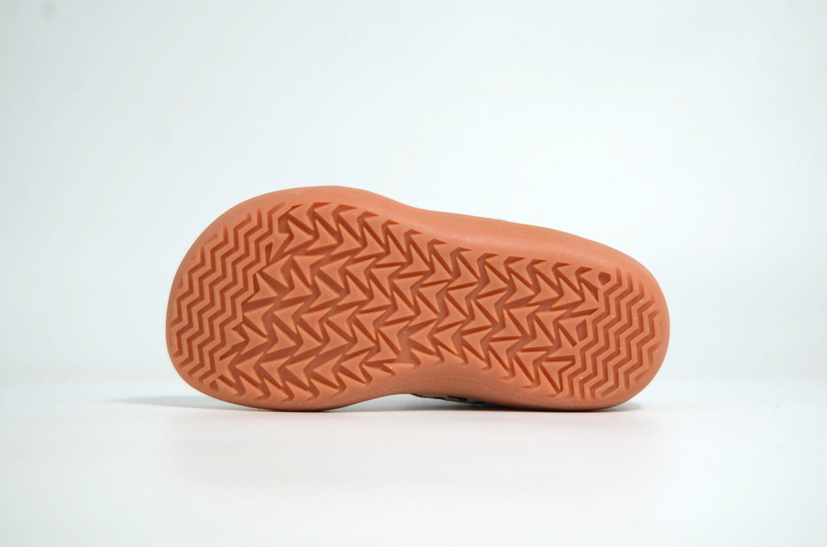 Athlete standing balanced in barefoot shoes demonstrating stability and ground feel