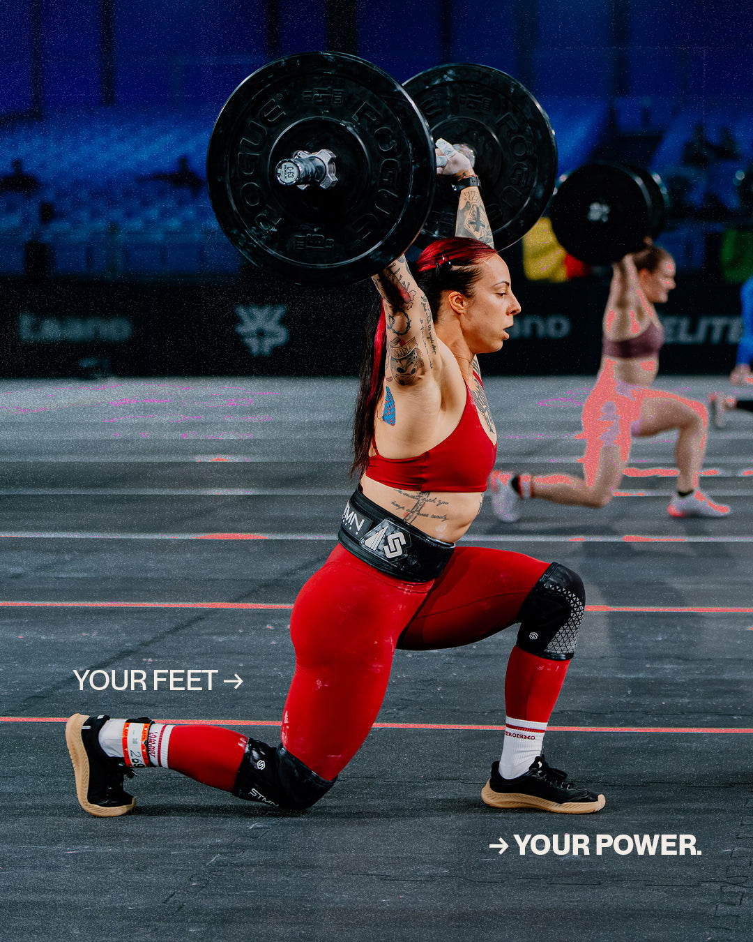 Athlete wearing The Nude Foot barefoot shoes mid-lunge with overhead barbell in a HYROX-style competition
