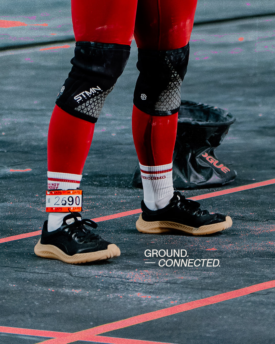 Athlete pulling a sled in The Nude Foot barefoot shoes, ground connected footwork for HYROX training