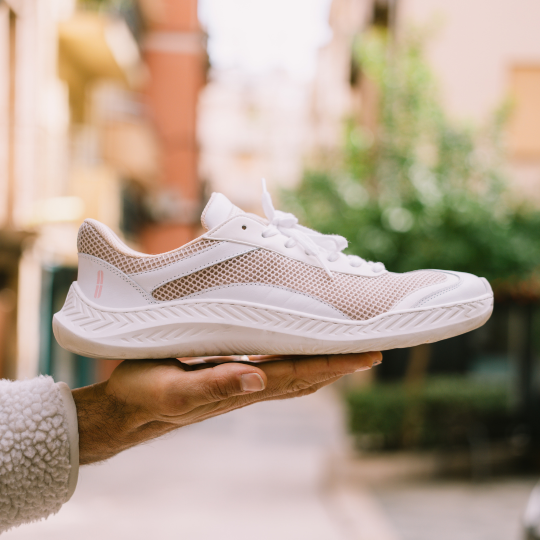 The Nude Foot Barefoot Sneaker Pure White - wide toe box minimalist sneaker held outdoors
