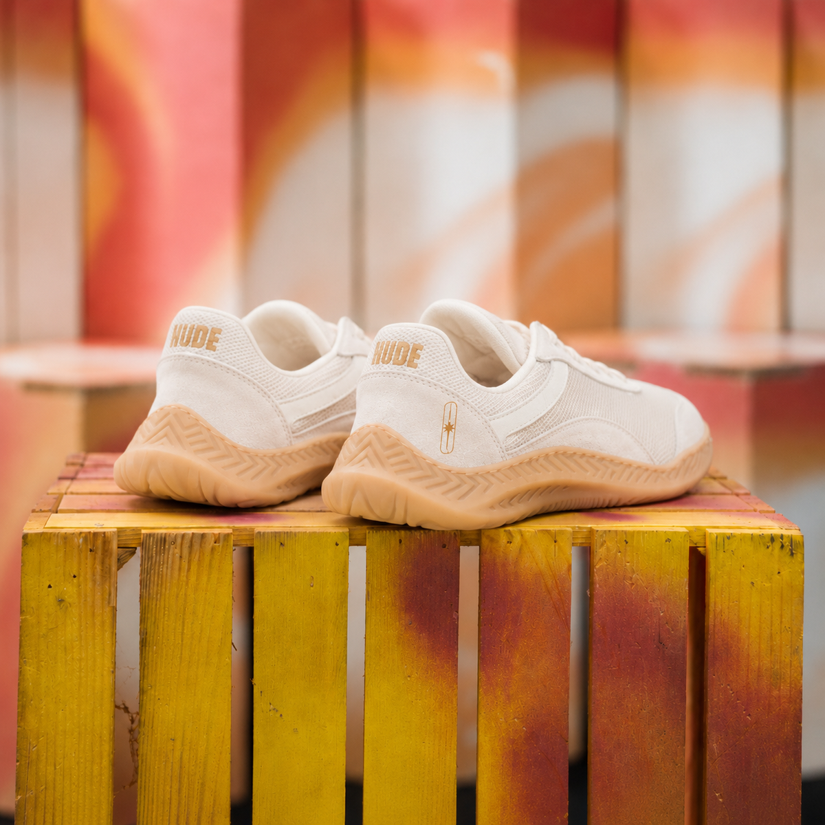 The Nude Foot Barefoot Sneaker Aura - rear view of off-white sneaker pair with gold NUDE heel branding