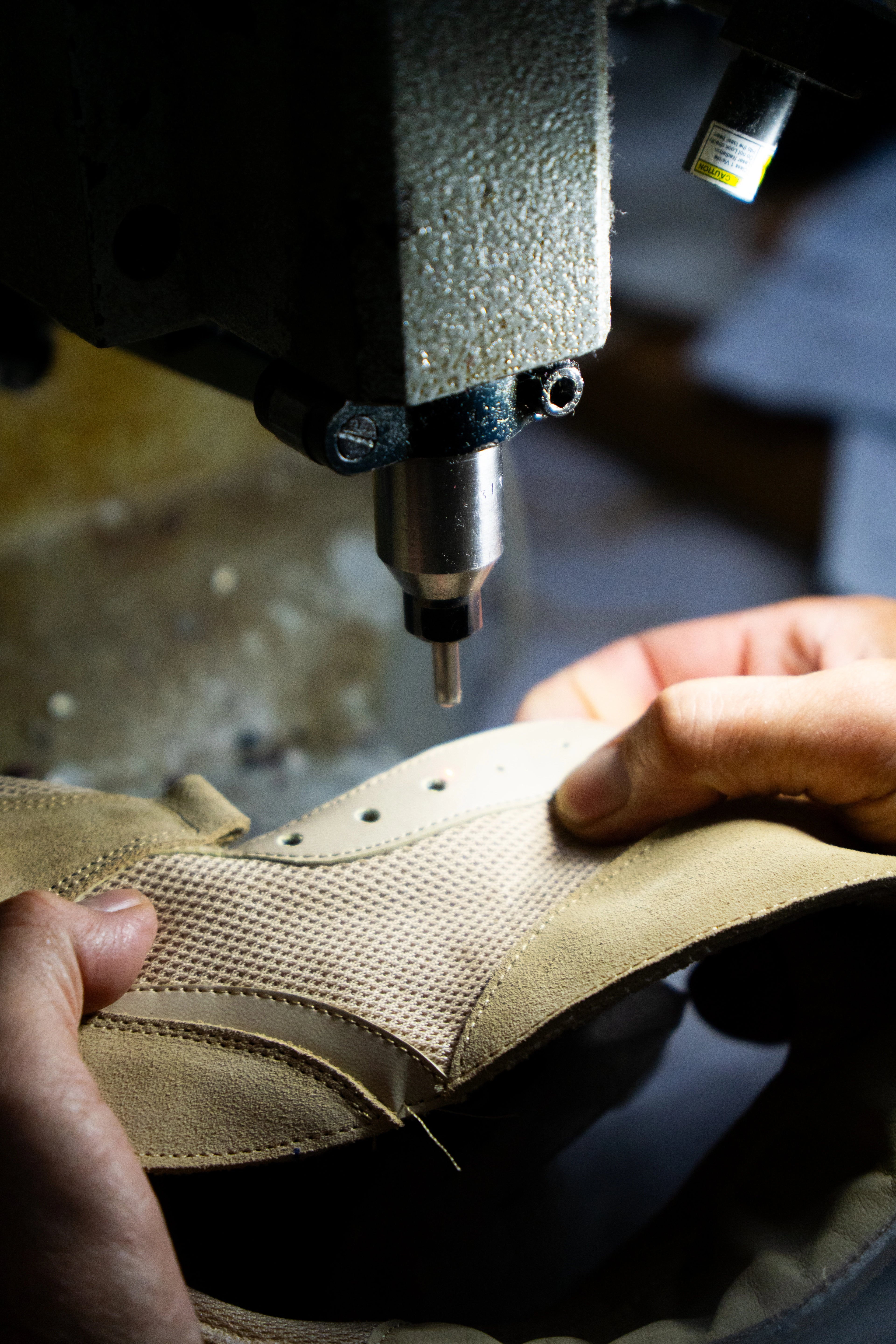 Close-up of a shoe being worked on with a drill bit